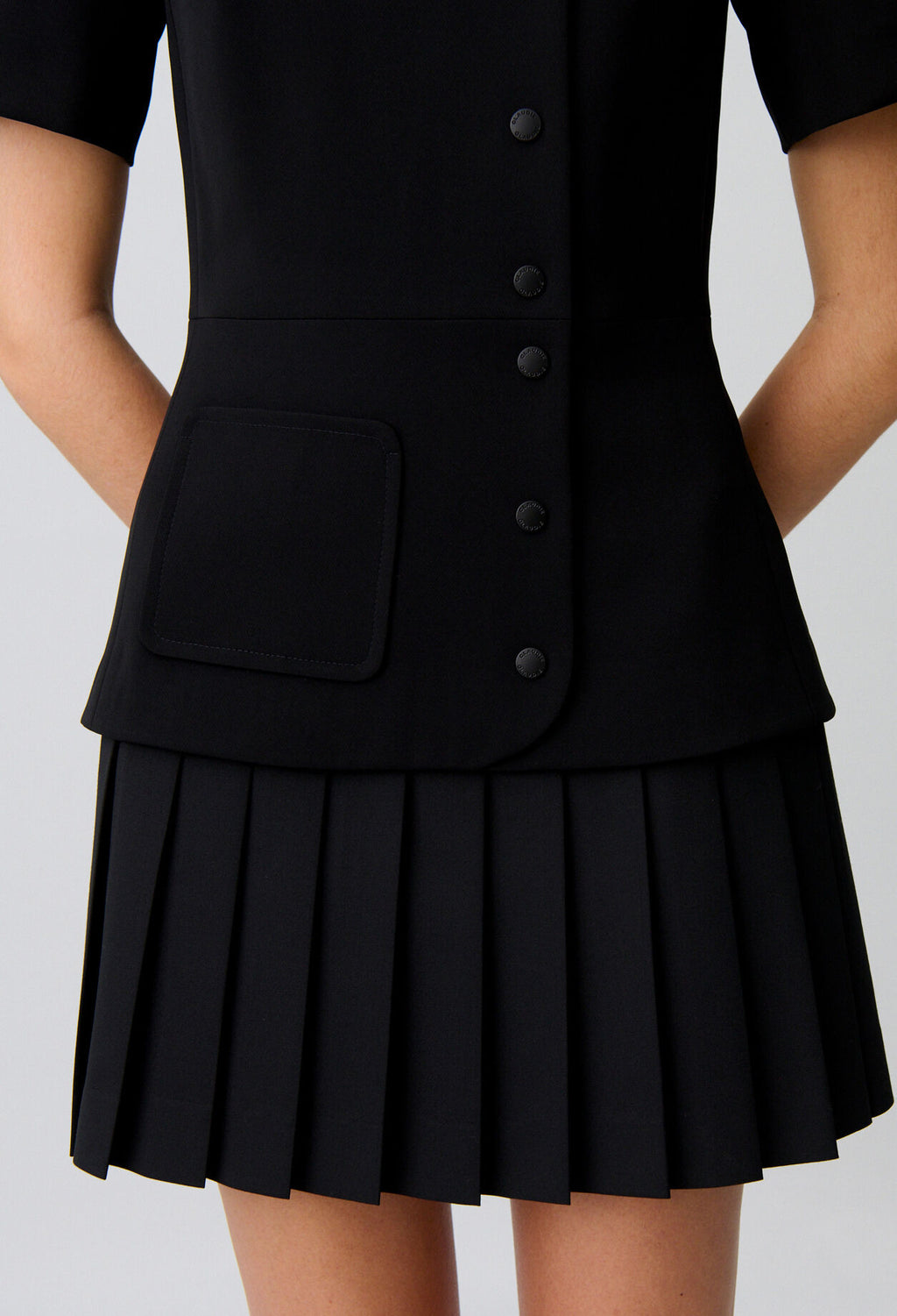 Short pleated peplum dress
