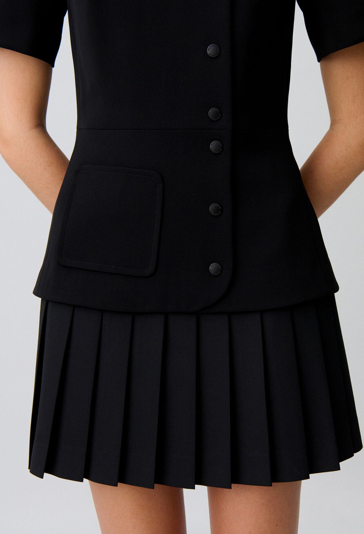 Short pleated peplum dress